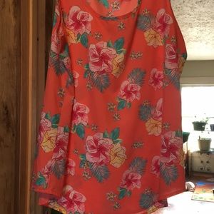 Sleeveless floral blouse.